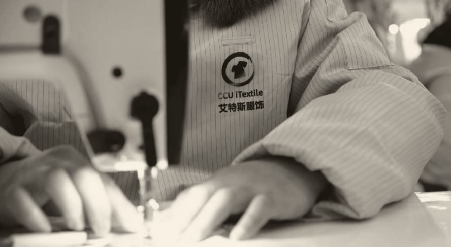 Hands guiding fabric through a sewing machine